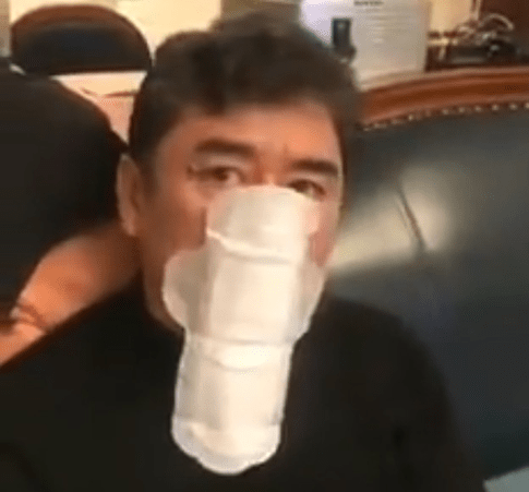 Man wearing sanitary pad as face mask